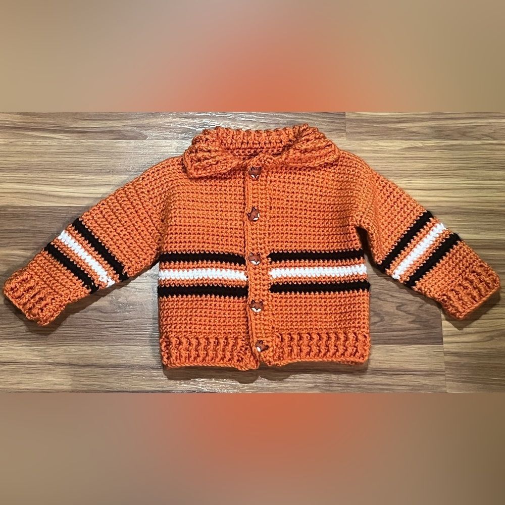 Hand-crocheted orange sweater with black and white stripes and Fox Buttons
